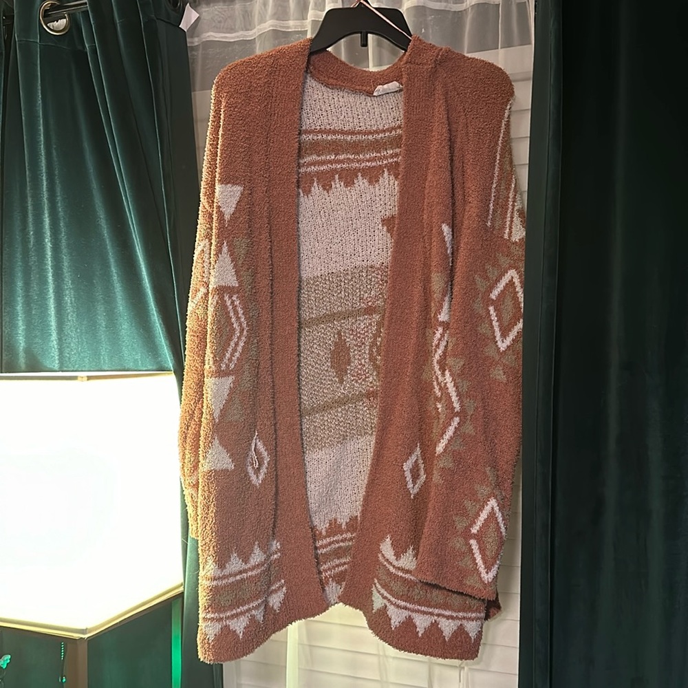 Large, orange and white cardigan.